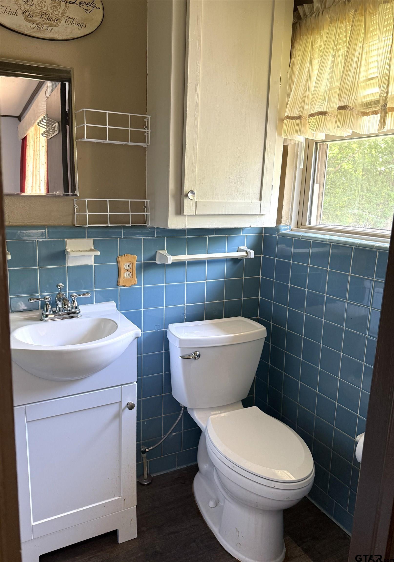 2015 East 5th Street Tyler, TX 75701 - Photo 19 of 32 a bathroom with a toilet sink and mirror