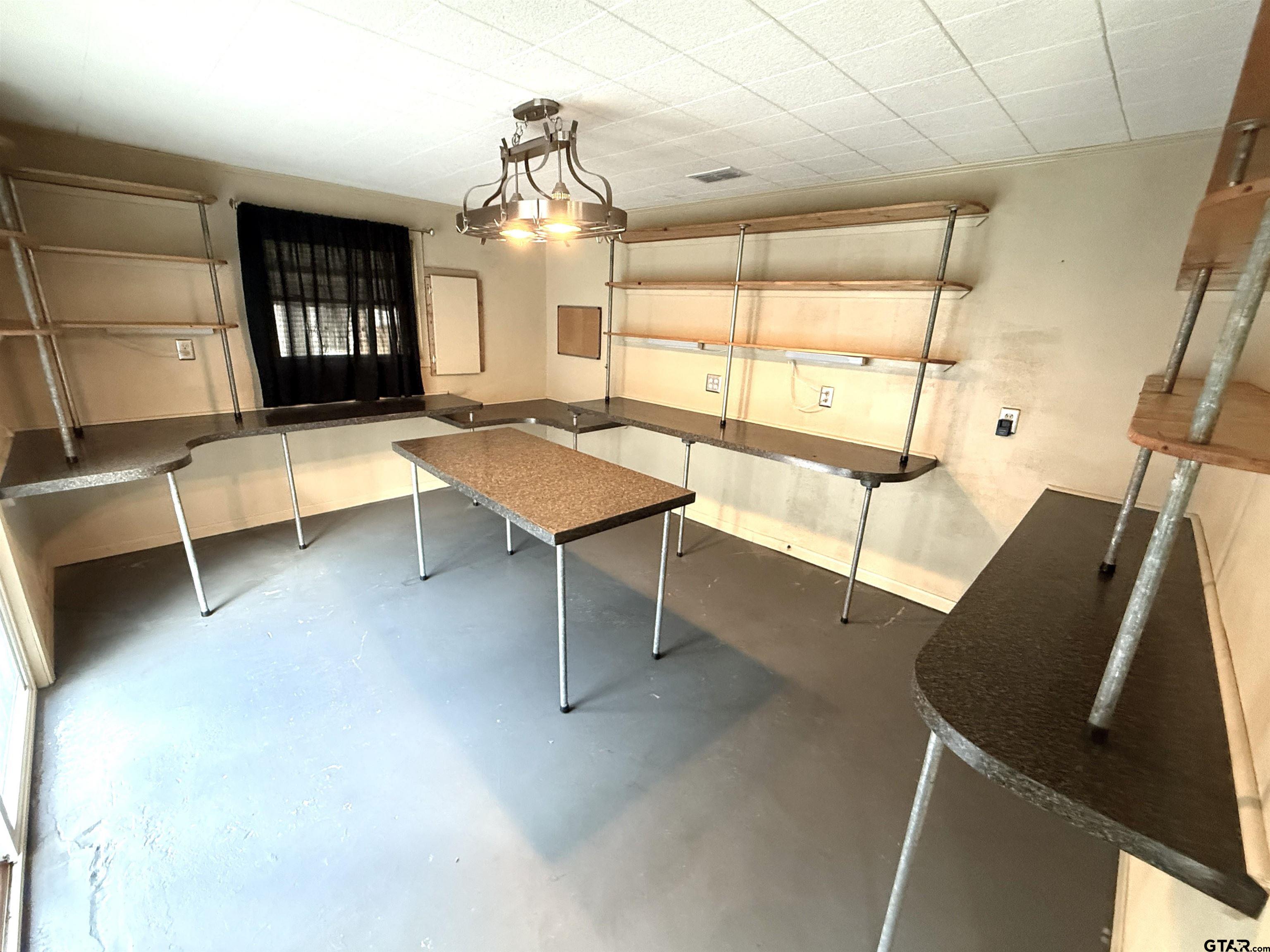 2015 East 5th Street Tyler, TX 75701 - Photo 23 of 32 a room with table chairs and wooden floor