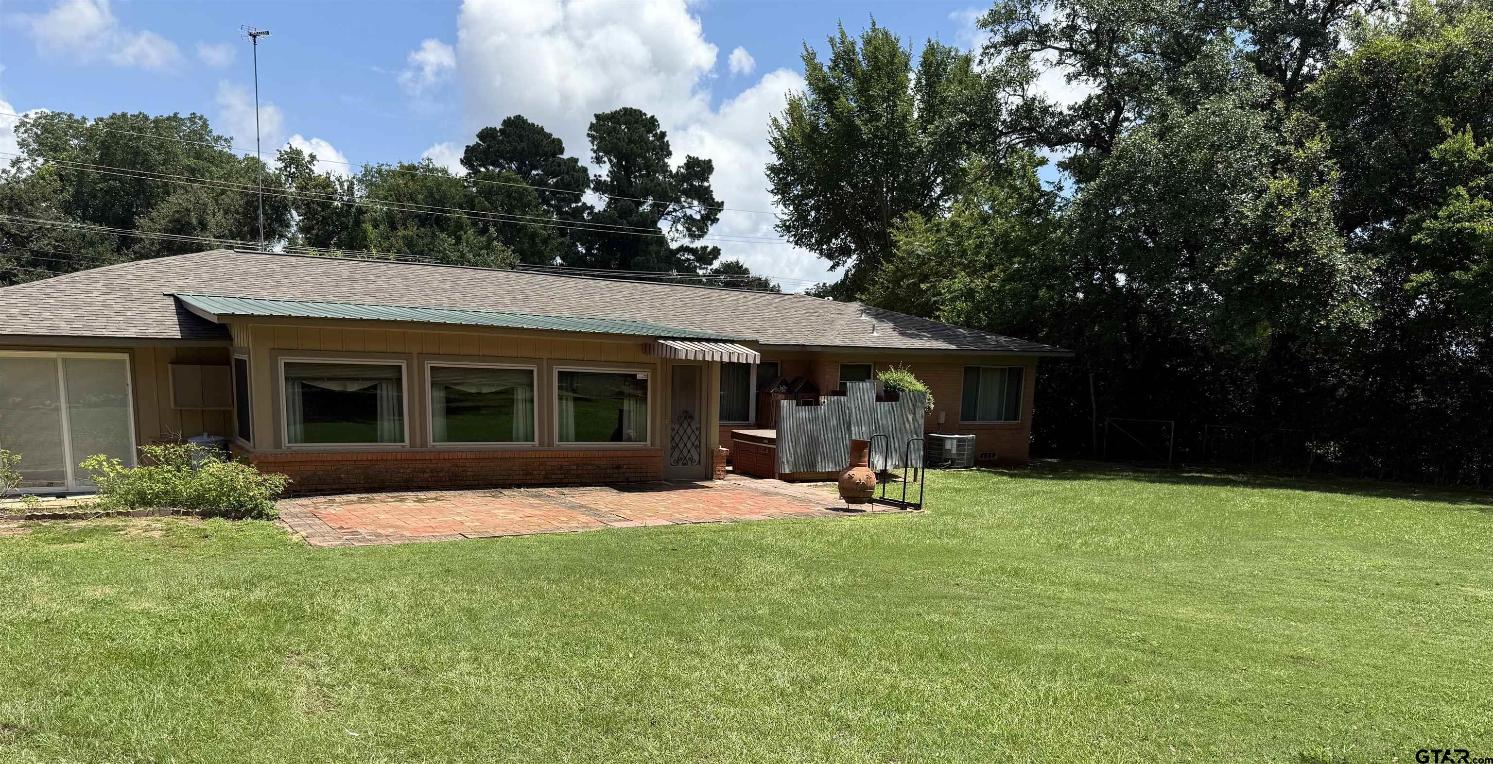 2015 East 5th Street Tyler, TX 75701 - Photo 30 of 32 a view of a house with a yard porch and sitting area