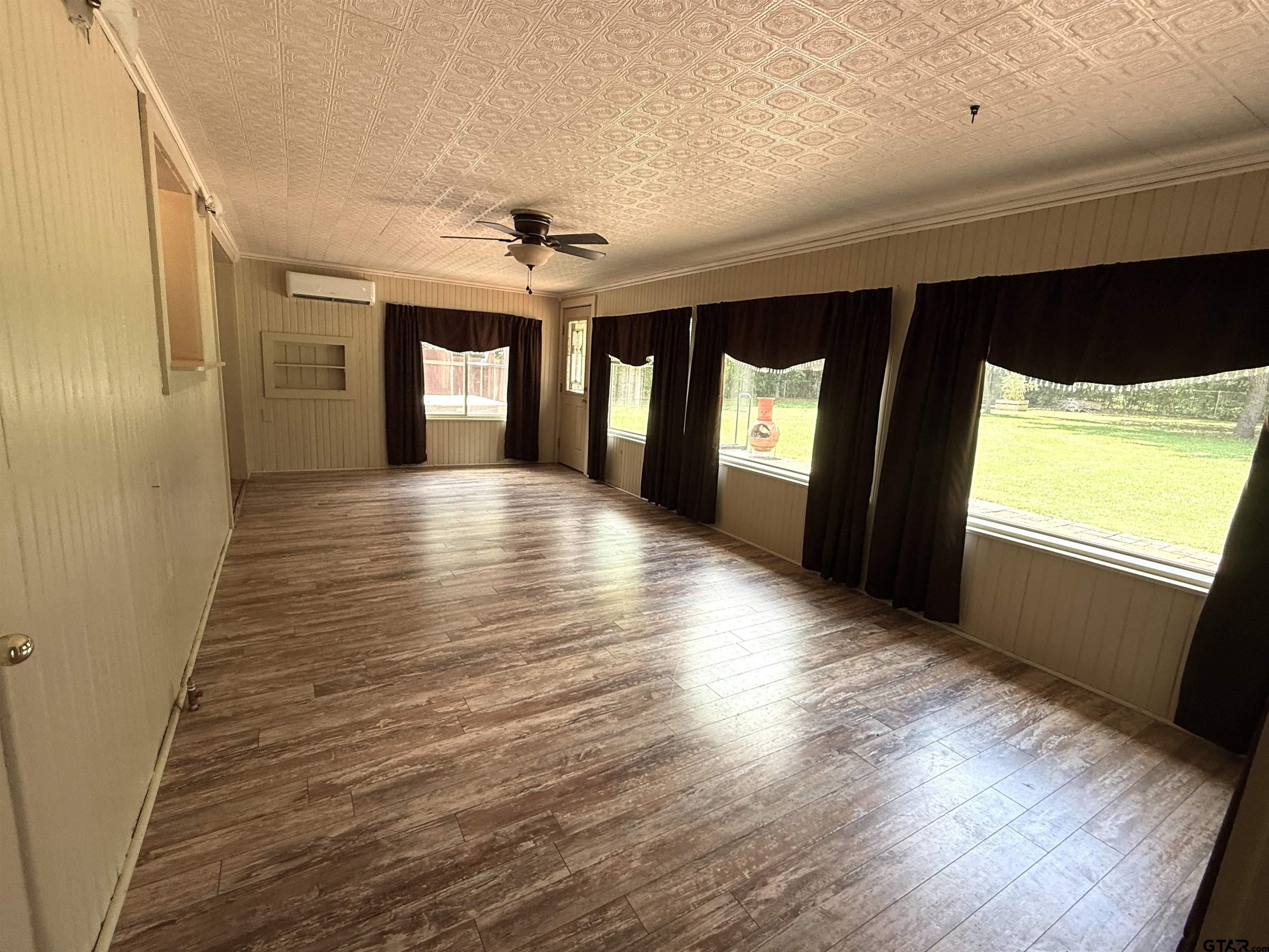 2015 East 5th Street Tyler, TX 75701 - Photo 9 of 32 a view of hallway with wooden floor and windows