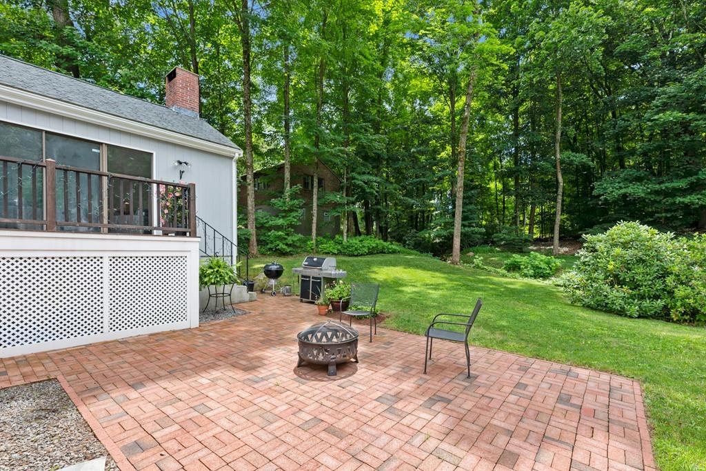 20 Cliff Road Wellesley, MA 02481 - Photo 17 of 21 a view of a backyard with table and chairs with a small yard and plants