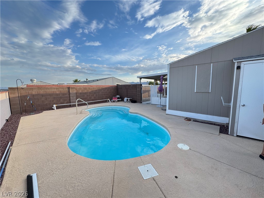 3250 Del Monte Street Laughlin, NV 89029 - Photo 46 of 57 A kidney-shaped inground pool invites relaxation in a private, fenced backyard setting.