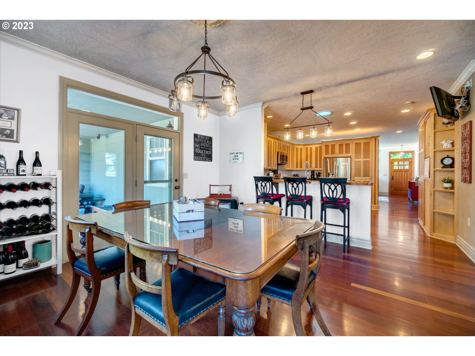 1675 South Boones Ferry Road Woodburn, OR 97071 - Photo 14 of 45 a dining room with furniture a chandelier and wooden floor
