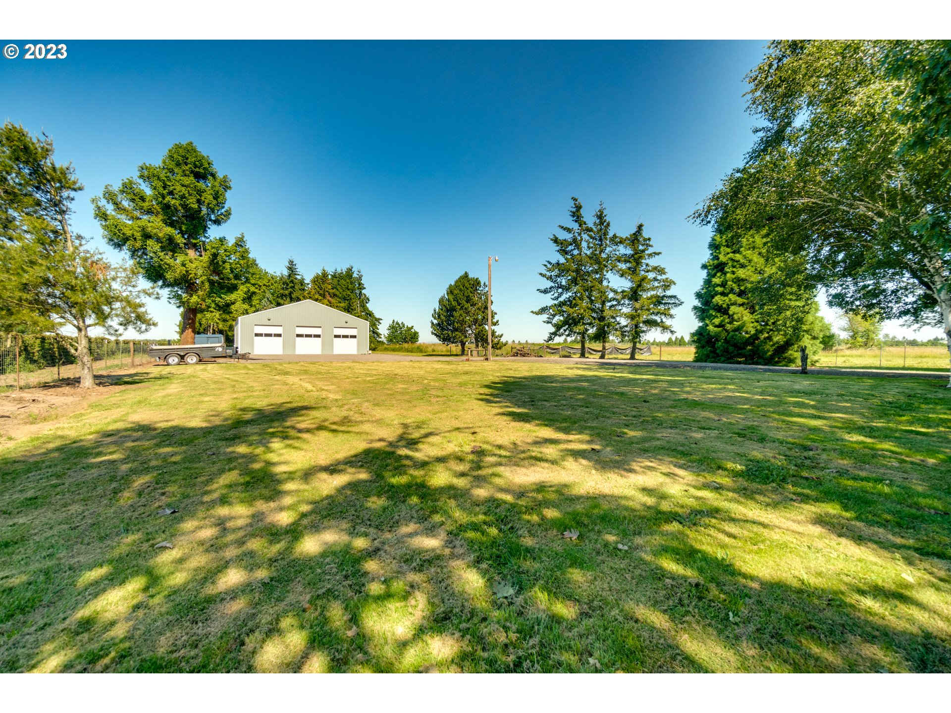 1675 South Boones Ferry Road Woodburn, OR 97071 - Photo 30 of 45 a view of yard with swimming pool and trees