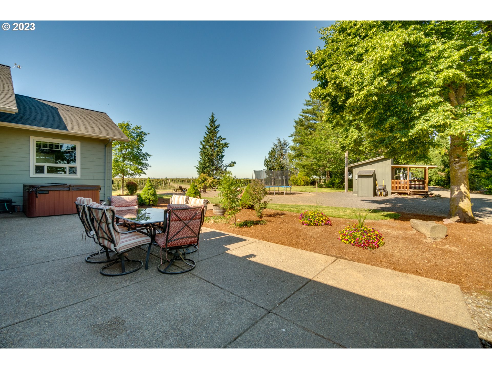 1675 South Boones Ferry Road Woodburn, OR 97071 - Photo 31 of 45 a backyard of a house with table and chairs