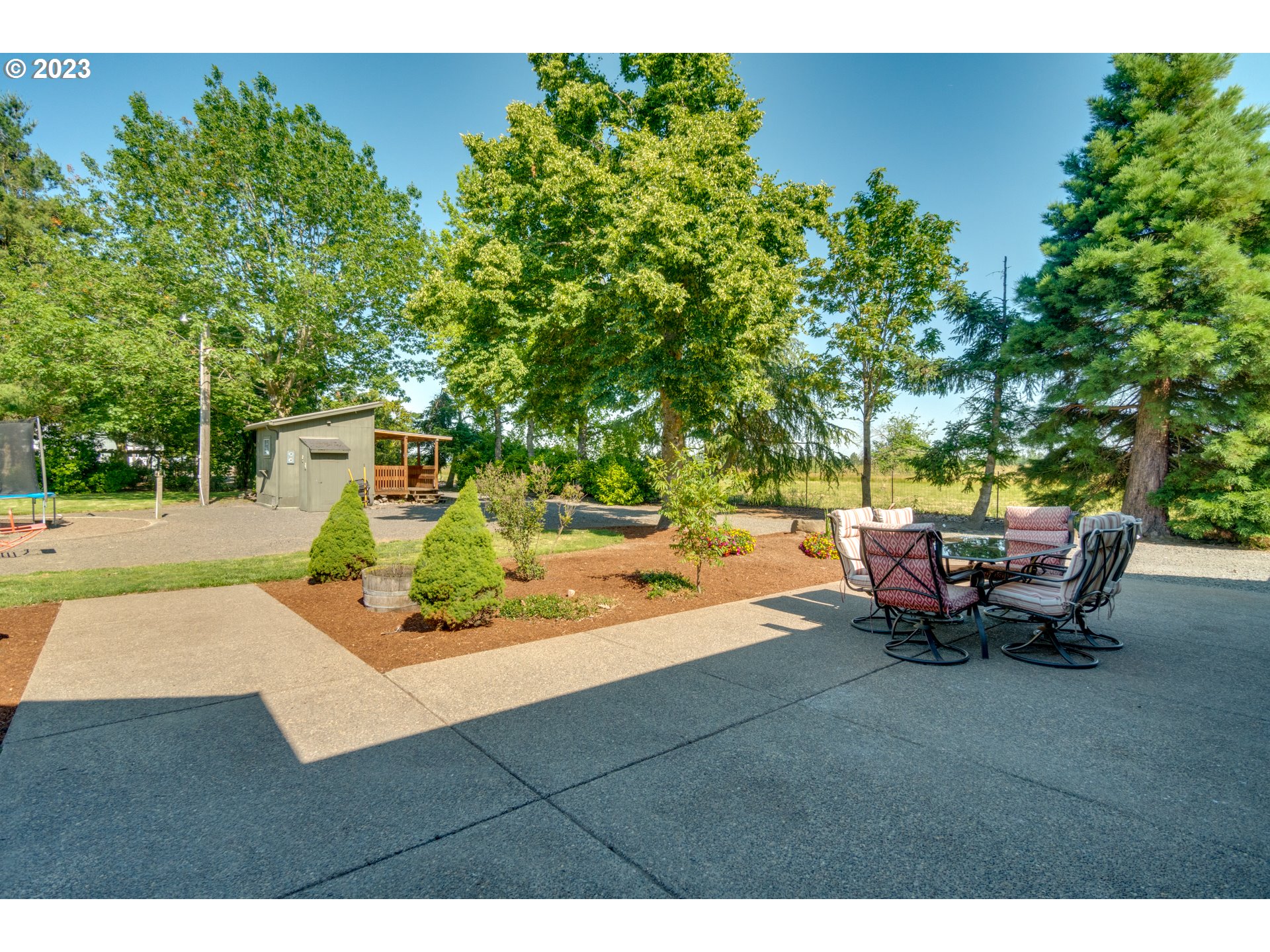 1675 South Boones Ferry Road Woodburn, OR 97071 - Photo 32 of 45 a backyard of a house with table and chairs