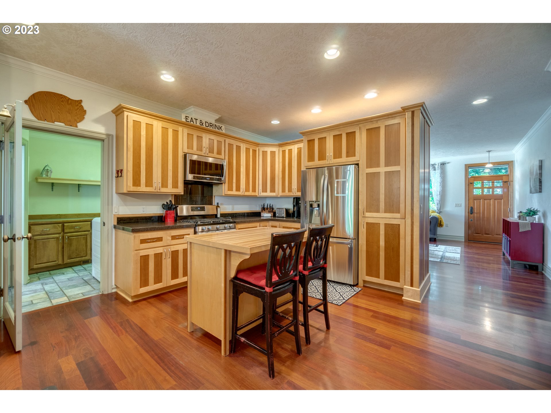 1675 South Boones Ferry Road Woodburn, OR 97071 - Photo 6 of 45 a kitchen with a table chairs refrigerator and cabinets
