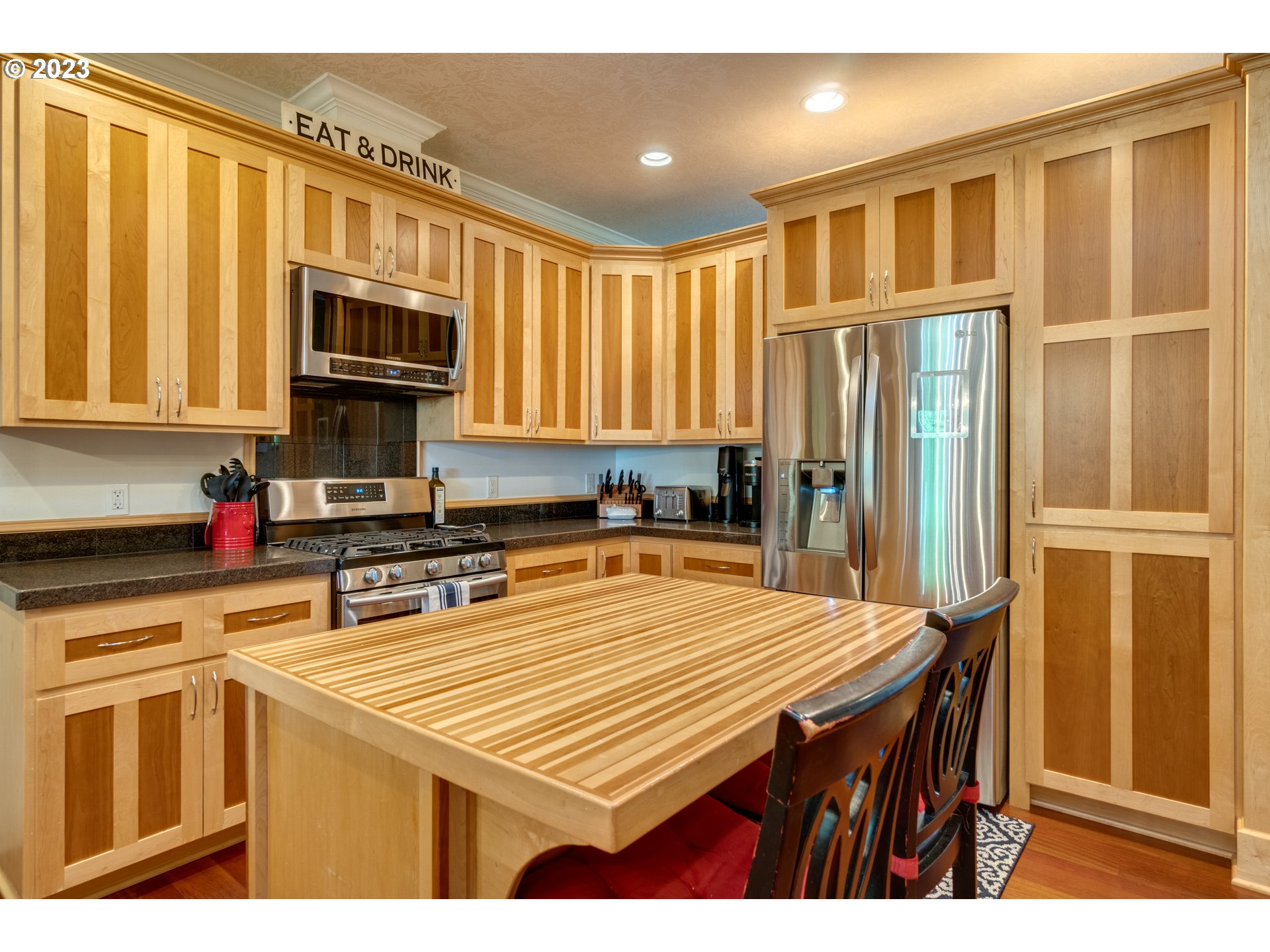1675 South Boones Ferry Road Woodburn, OR 97071 - Photo 7 of 45 a kitchen with stainless steel appliances granite countertop a stove top oven a sink dishwasher and cabinets with wooden floor