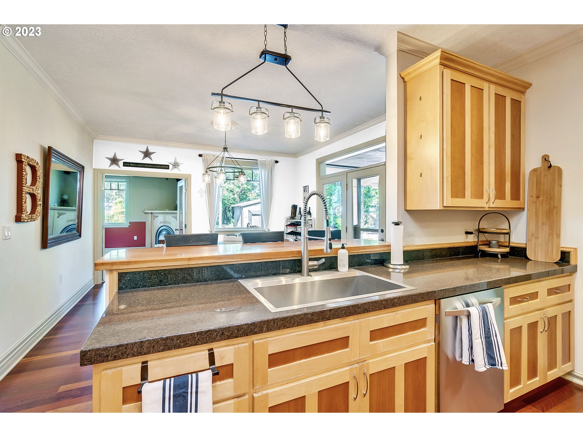 1675 South Boones Ferry Road Woodburn, OR 97071 - Photo 8 of 45 a kitchen with kitchen island a counter top space a sink stainless steel appliances and cabinets