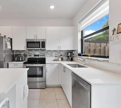 a kitchen with a sink stove and microwave