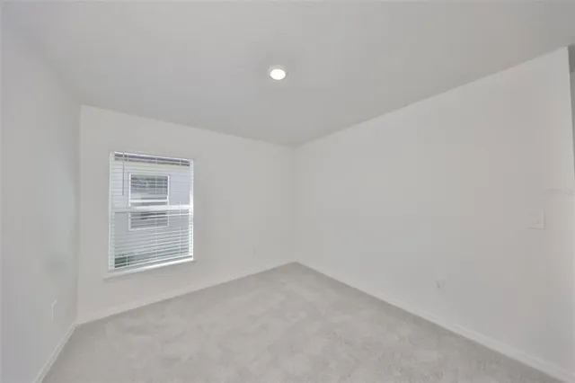 a view of an empty room and a window