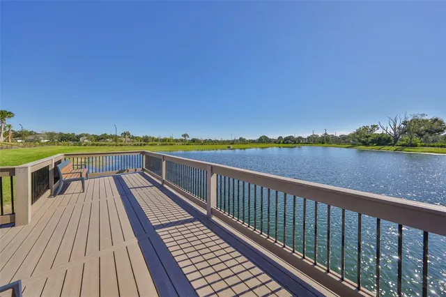 a view of a patio with table and chairs under an umbrella
