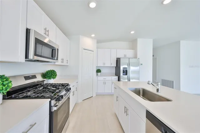 a kitchen with a sink a stove and refrigerator