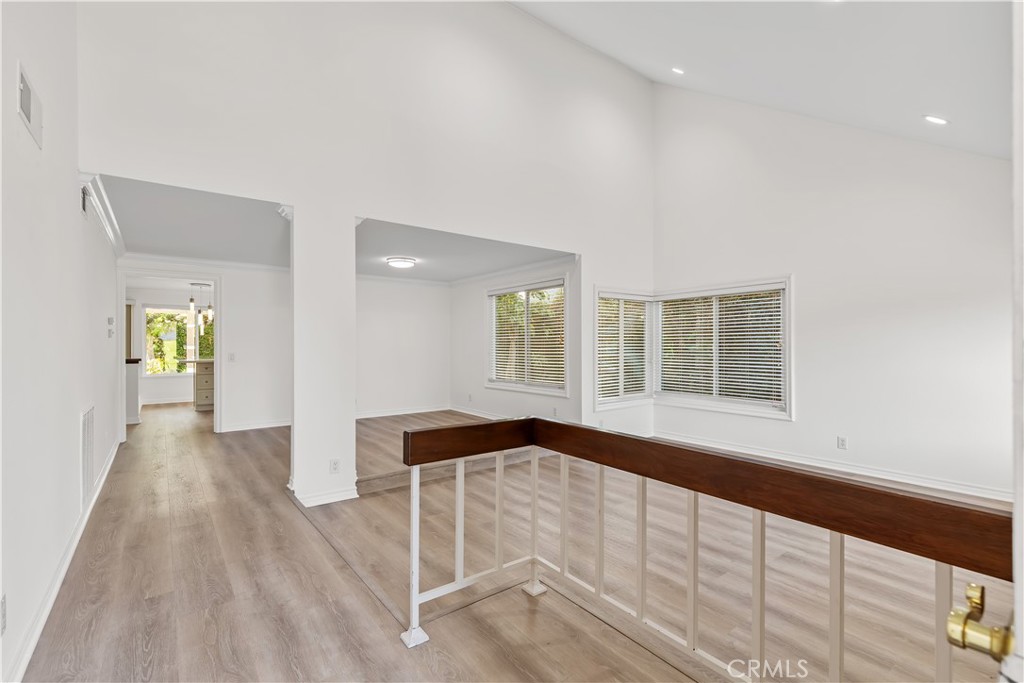19 Alameda Irvine, CA 92620 - Photo 14 of 55 a view of an empty room with wooden floor and a window