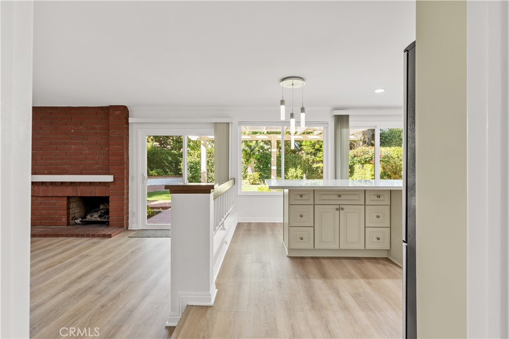 19 Alameda Irvine, CA 92620 - Photo 20 of 55 an empty room with wooden floor a fireplace and windows