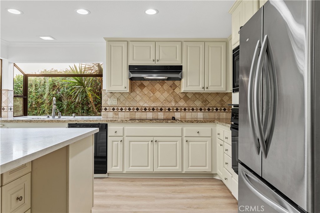 19 Alameda Irvine, CA 92620 - Photo 22 of 55 a kitchen with stainless steel appliances granite countertop a refrigerator and a stove
