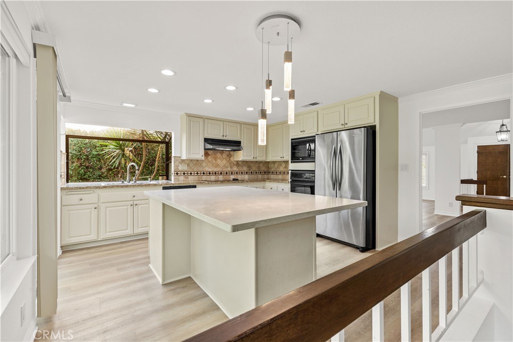 19 Alameda Irvine, CA 92620 - Photo 23 of 55 a kitchen with a refrigerator a sink and cabinets