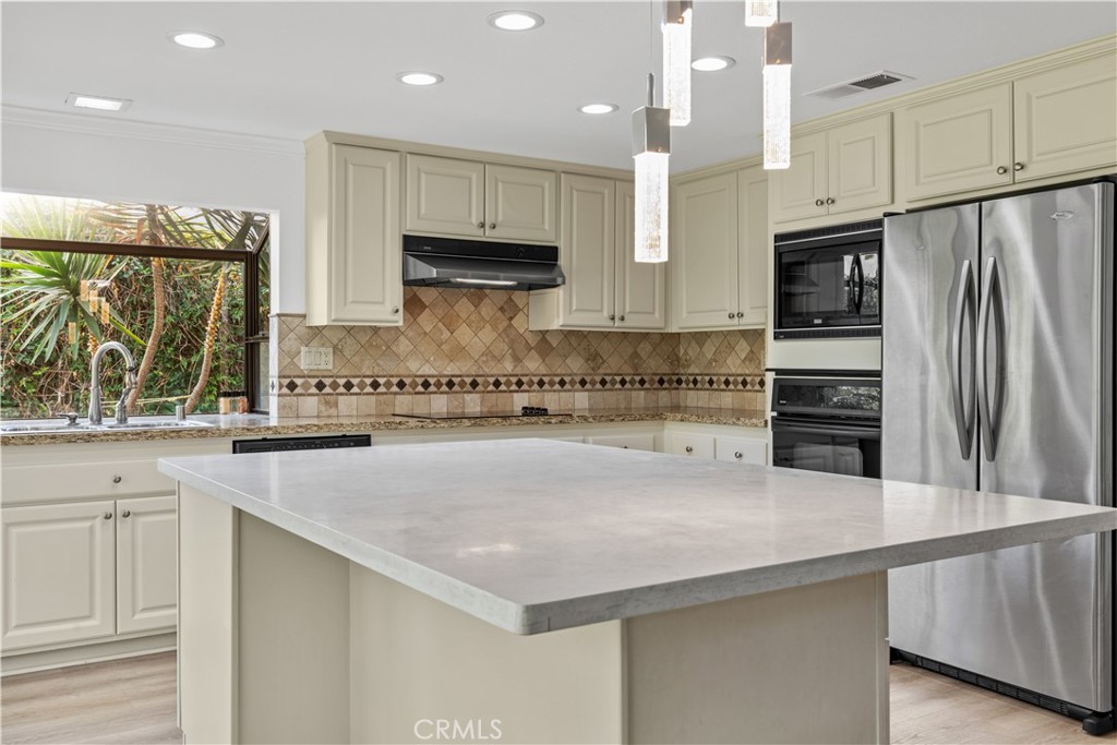 19 Alameda Irvine, CA 92620 - Photo 24 of 55 a kitchen with stainless steel appliances a refrigerator and a stove top oven