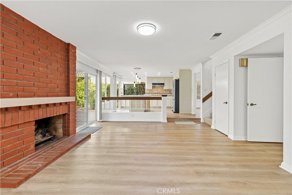 19 Alameda Irvine, CA 92620 - Photo 29 of 55 a view of a livingroom with wooden floor and a fireplace