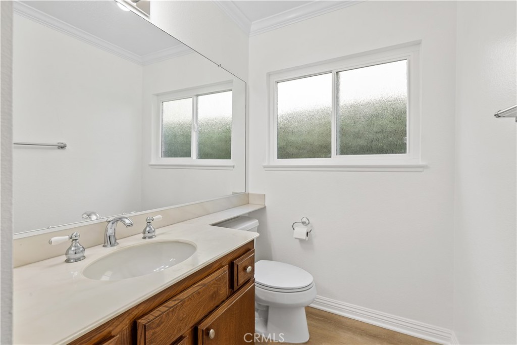 19 Alameda Irvine, CA 92620 - Photo 32 of 55 a bathroom with a granite countertop sink a toilet and a window