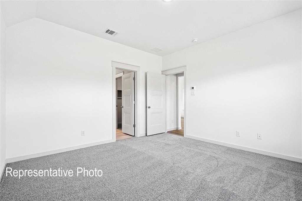 2709 Baker Farm Road Forney, TX 75126 - Photo 8 of 10 Neutral wall color, light gray carpeting, crisp white trim, and white interior doors