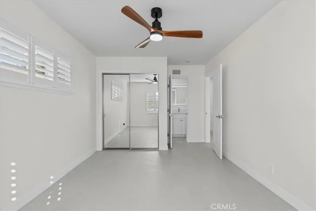 a view of empty room with ceiling fan