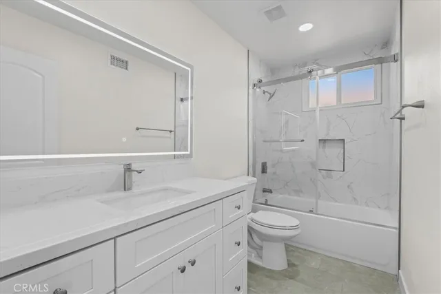 a bathroom with a sink toilet a shower and a mirror