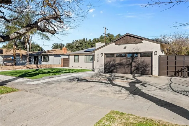 a front view of a house with a garden and patio