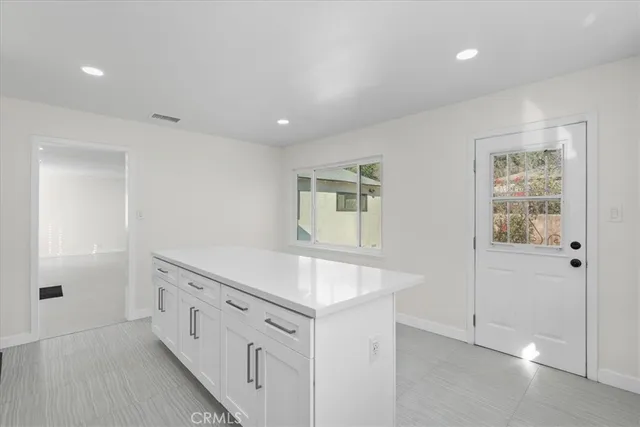 a kitchen with appliances a sink and cabinets