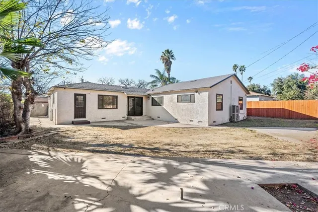 a front view of a house with a yard table and chairs
