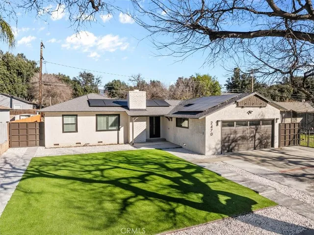 an aerial view of residential houses with outdoor space and trees