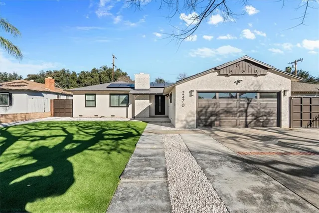 a front view of a house with a garden