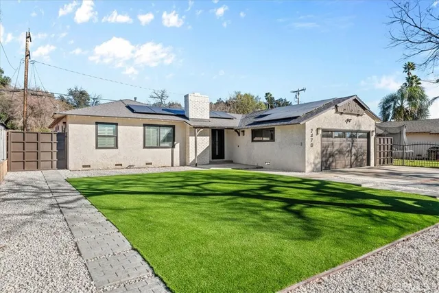 a front view of a house with a garden