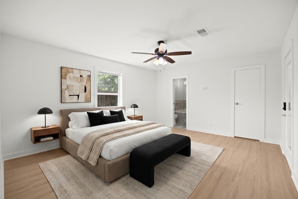 2836 Lockett Street Houston, TX 77021 - Photo 10 of 22 a bedroom with a large bed and a ceiling fan