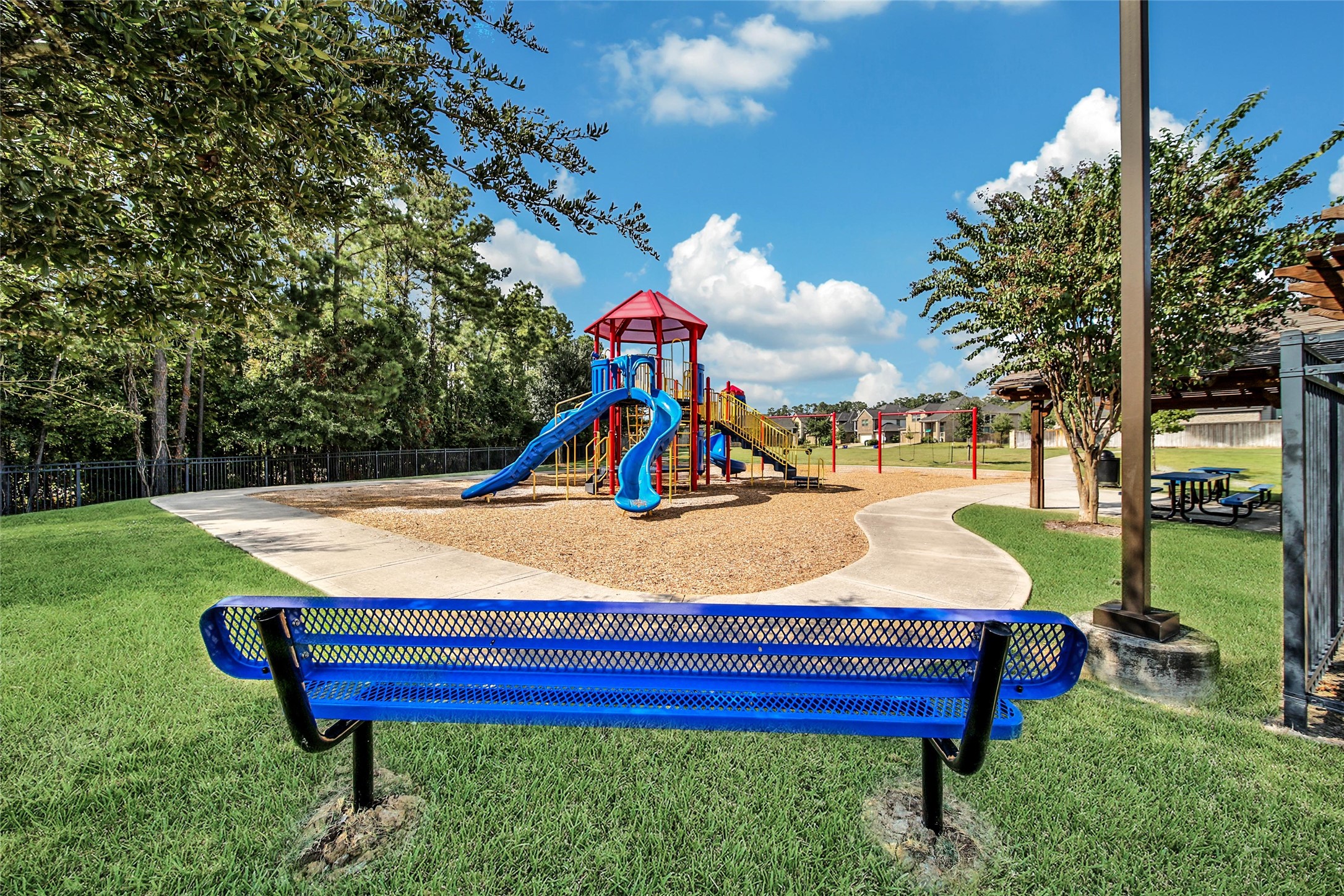 214 Pleasant Hill Way Conroe, TX 77304 - Photo 40 of 43 Keep an eye on the kiddos playing from one of the park benches.