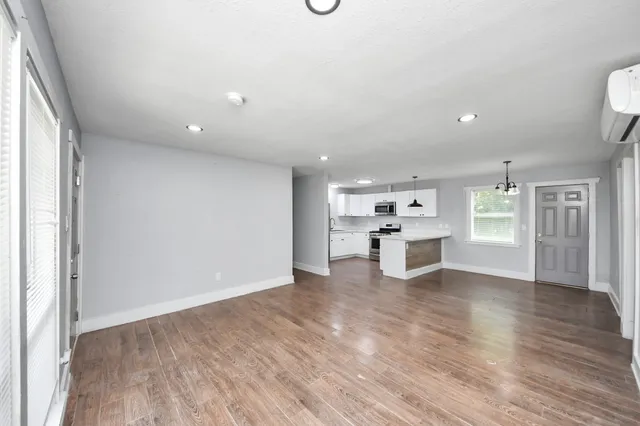 a view of a kitchen with furniture and wooden floor