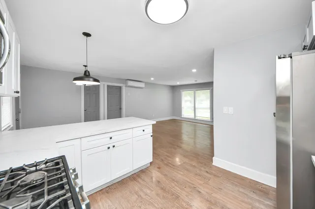 a kitchen with granite countertop a stove and a sink