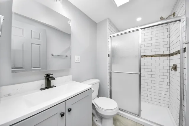 a bathroom with a sink toilet and shower