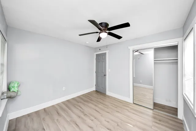 a view of empty room with wooden floor