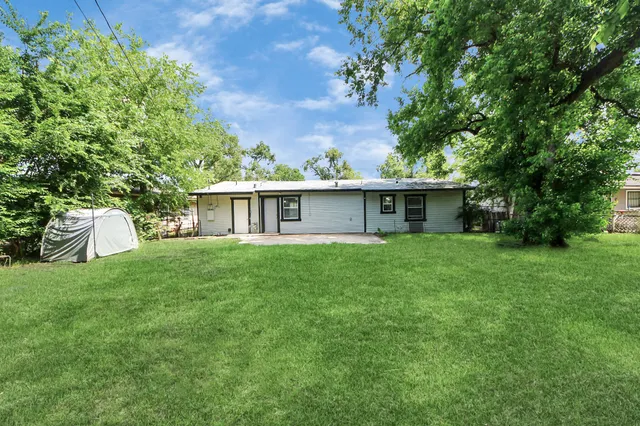 a front view of house with a garden