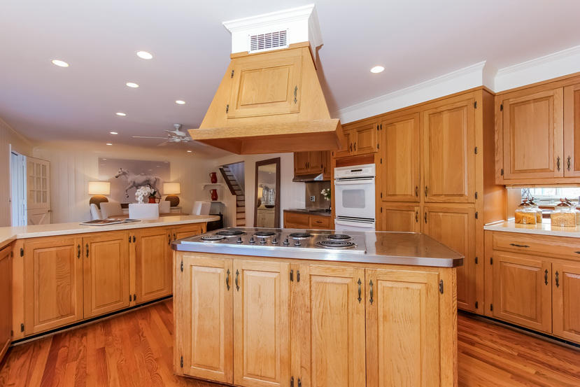 40 Allwood Road Darien, CT 06820 - Photo 20 of 50 a kitchen with kitchen island granite countertop wooden cabinets and white appliances