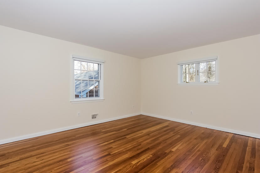 40 Allwood Road Darien, CT 06820 - Photo 40 of 50 an empty room with wooden floor and windows