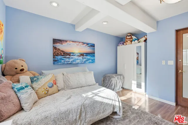 a bedroom with a bed and a painting on the wall