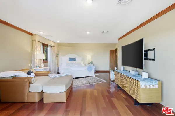 a living room with furniture wooden floor and a flat screen tv