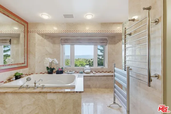 a view of bathroom with bathtub and shower