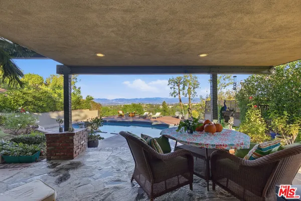 a outdoor dining space with furniture and garden view