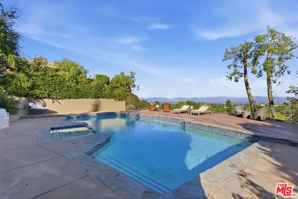 a view of a swimming pool with an outdoor seating