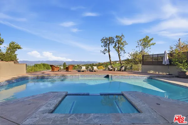 a view of a swimming pool and an outdoor seating