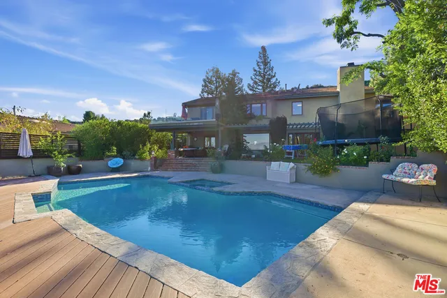 a view of a swimming pool with a patio
