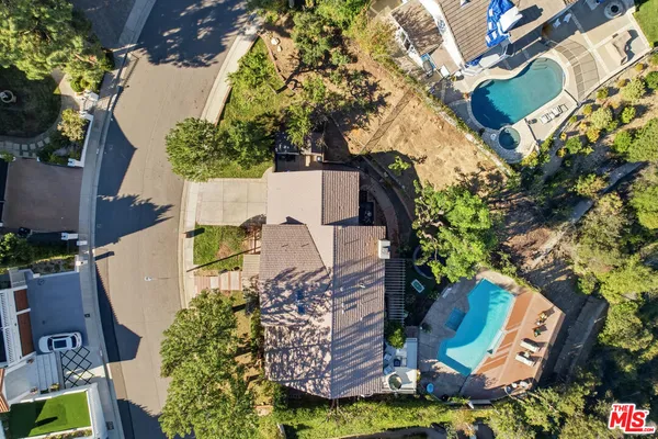 an aerial view of a house with yard swimming pool and outdoor seating
